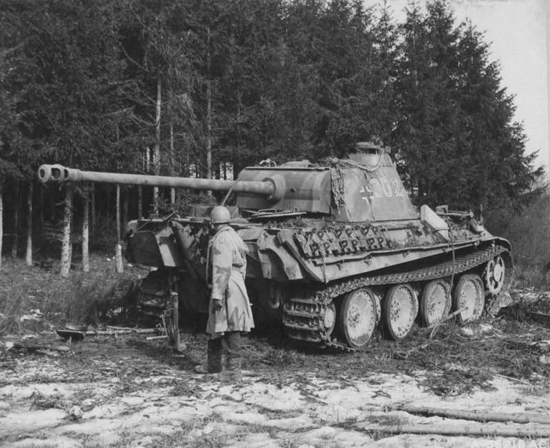 Panzer V Panther Ausf. D medium tank examined by an american soldier in the Ardennes (1944-1945)
