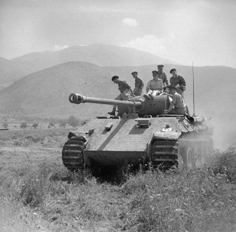 Captured PzKpfw V Panther during a display of enemy equipment in 2 June 1944, italy. British General Leese and other officers ride on the German tank.